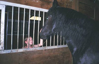 Cierra pets Mojo Willy's nose. Mojo is blind and was rescued from certain death.